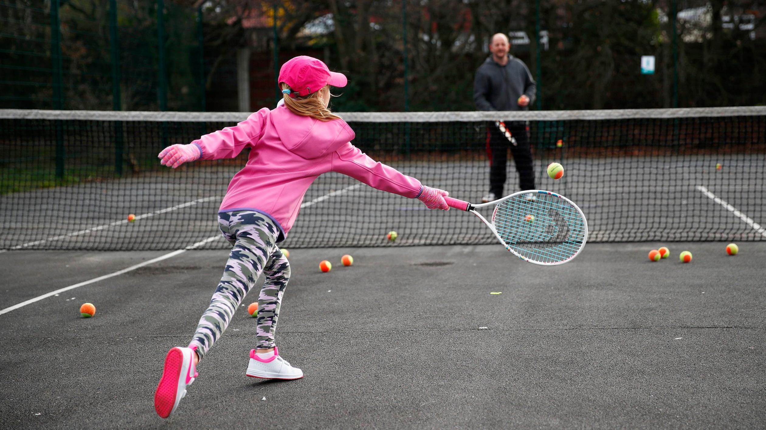 Child playing tennis