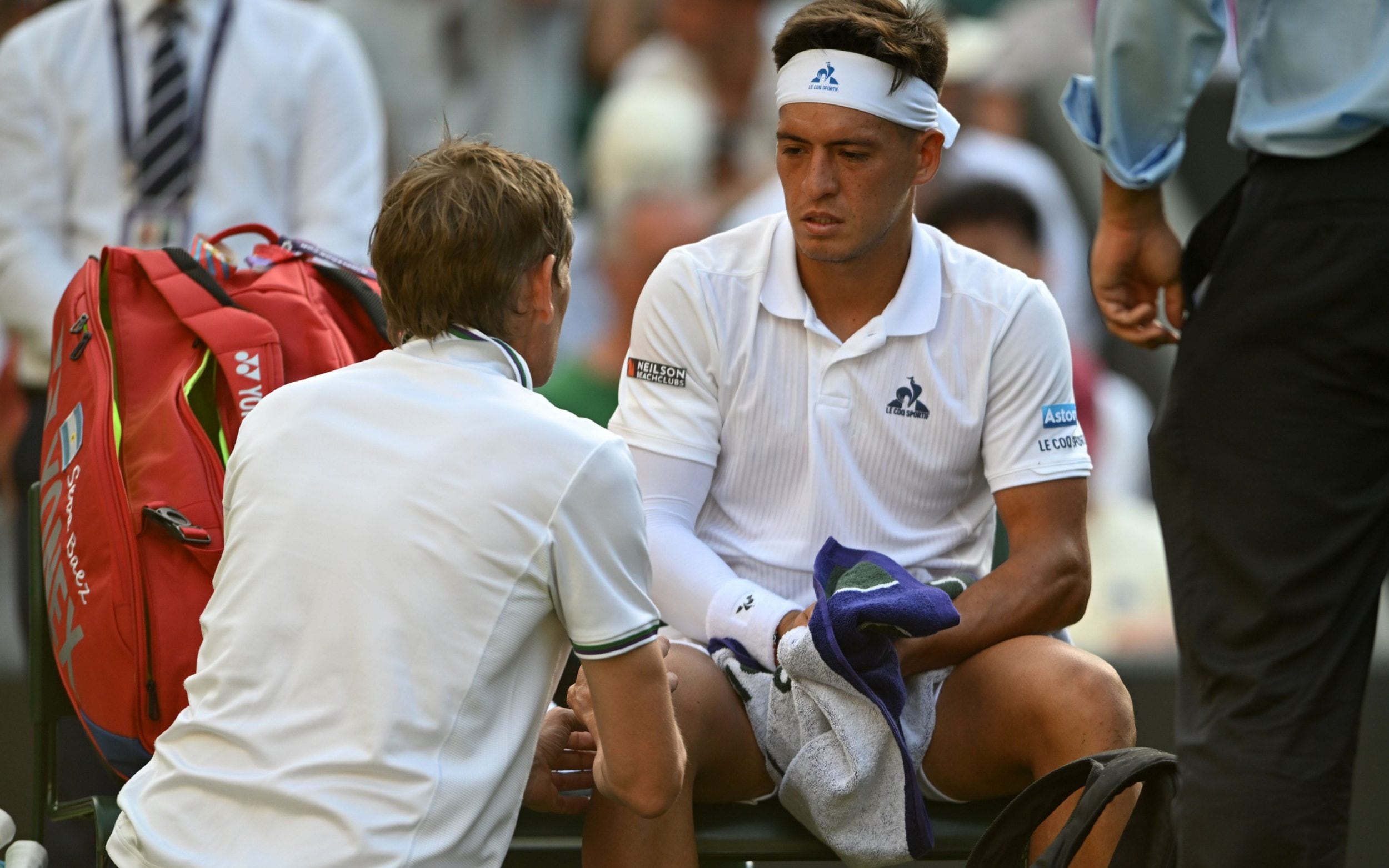 Sebastian Baez receives treatment during his first-round match with Draper before the Argentine later retired injured