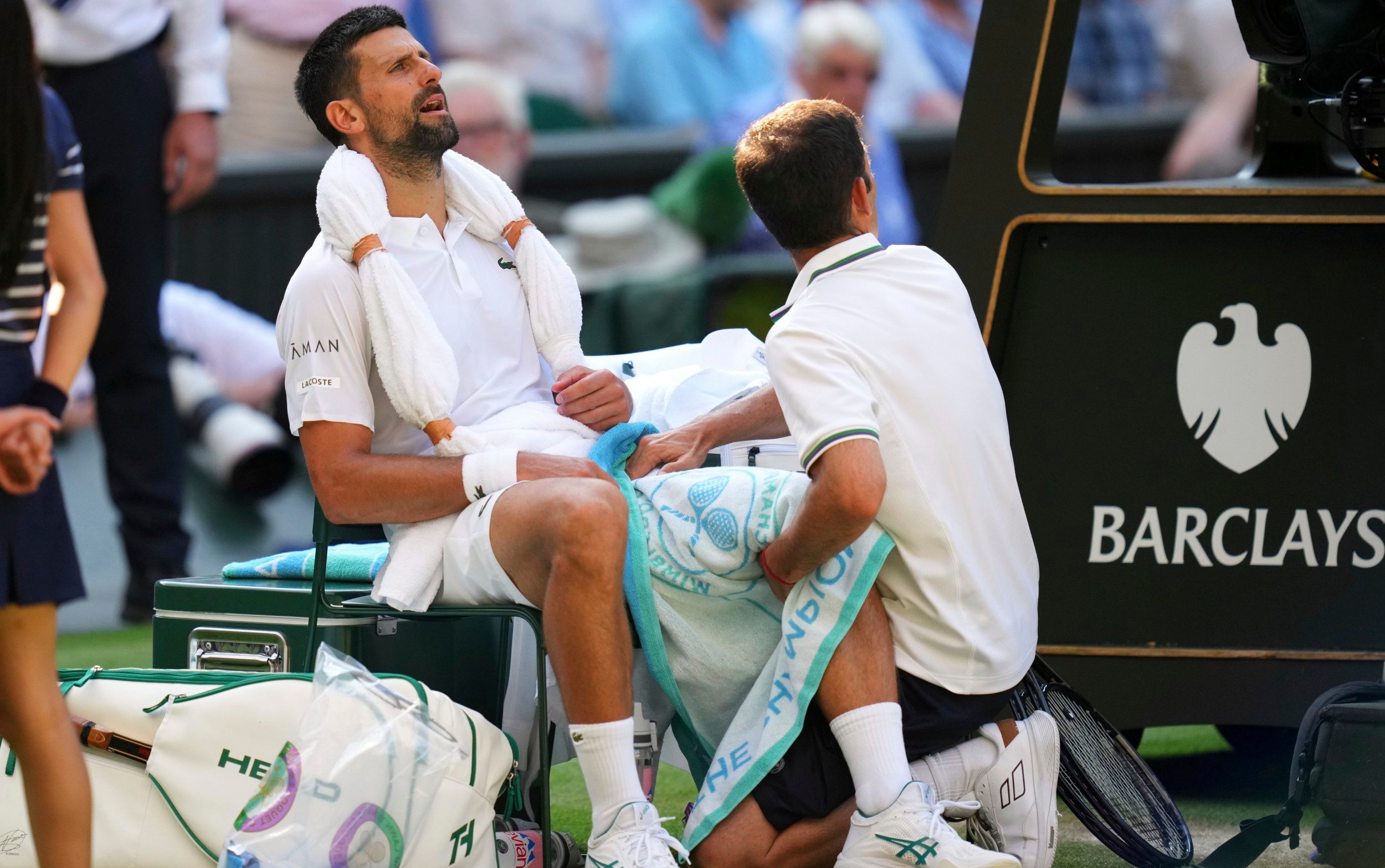 Novak Djorkovic of Serbia gets medical assistance