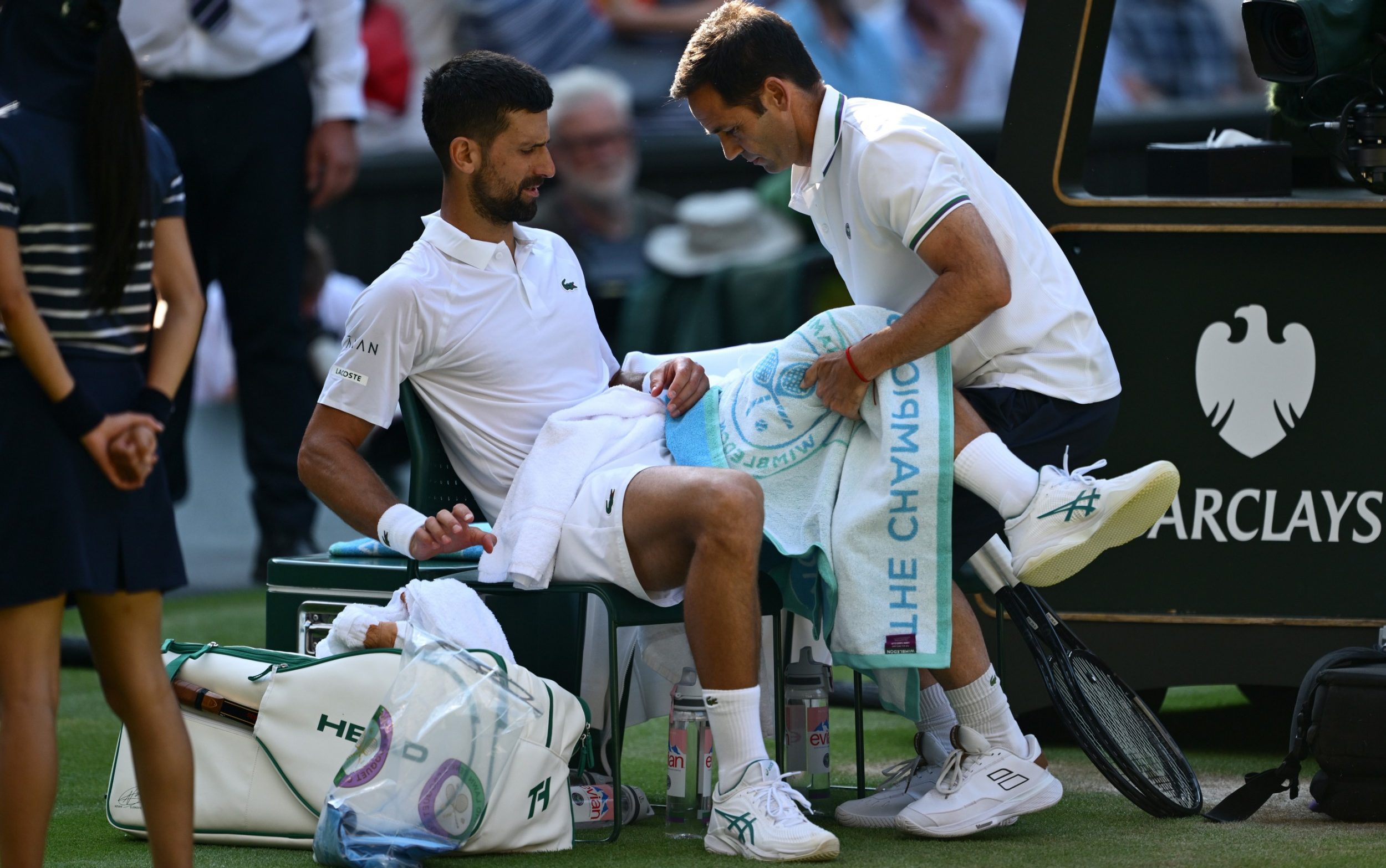 Novak Djokovic receives treatment during his Wimbledon semi-final defeat by Jannik Sinner