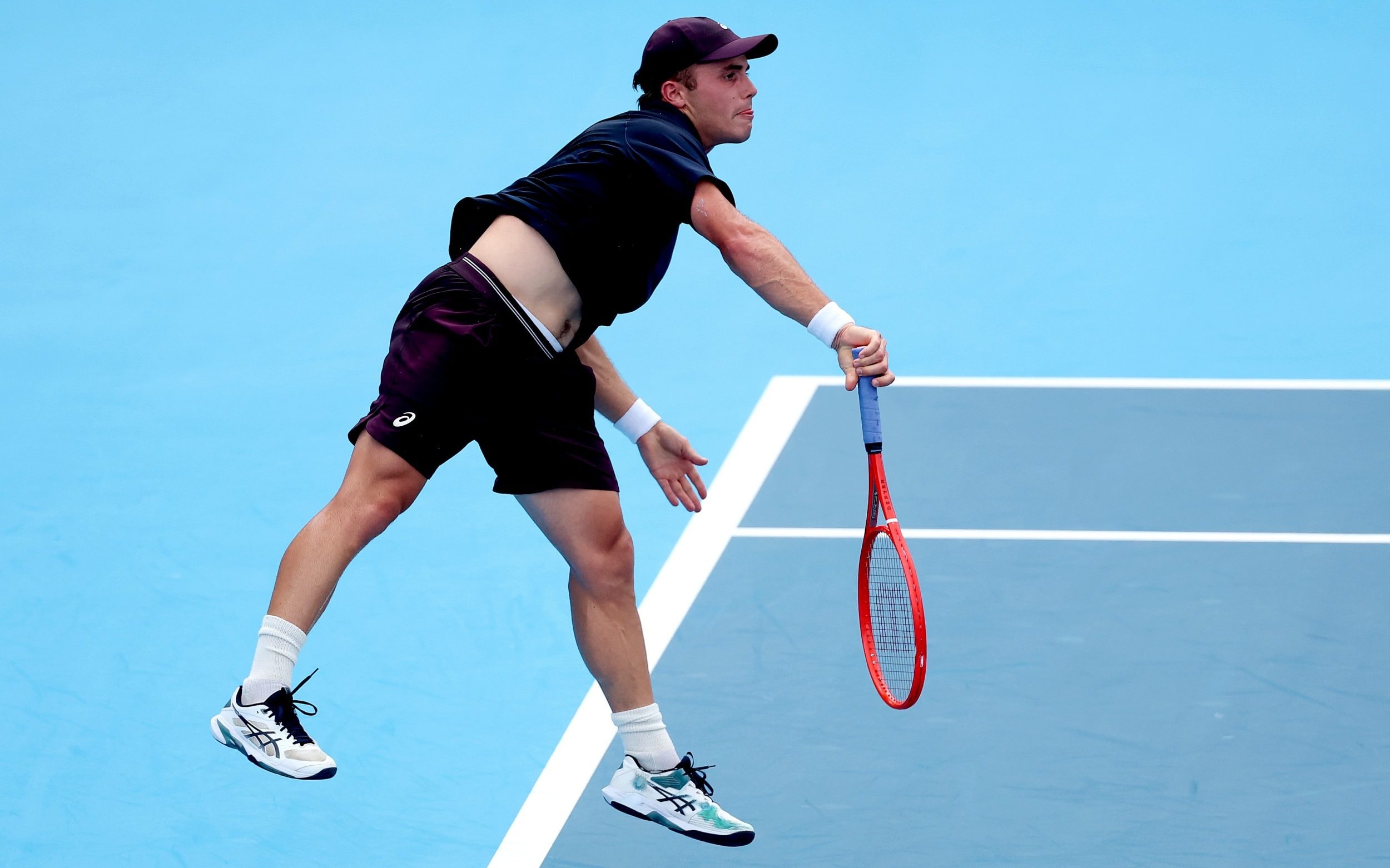 Arthur Fery of Great Britain serves to Alex de Minaur of Australia