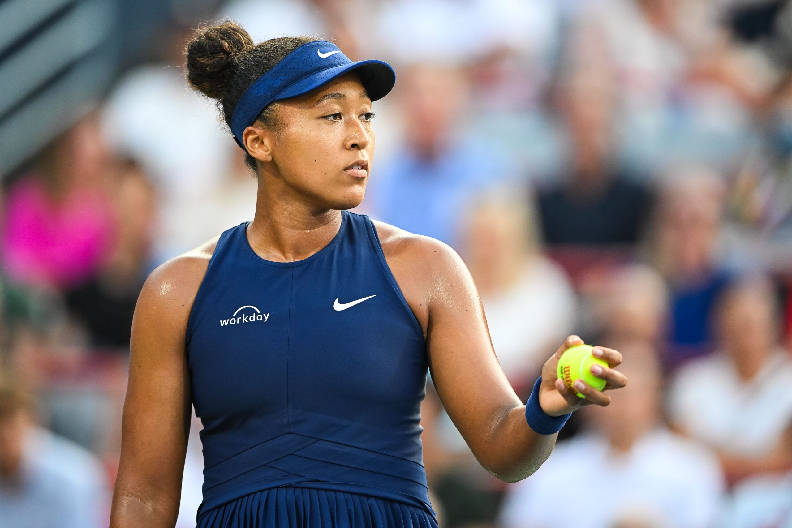 Aug 7, 2025; Montreal, QC, Canada; Naomi Osaka (JPN) serves the ball to Victoria Mboko (CAN) during singles final play at IGA Stadium. © David Kirouac-Imagn Images