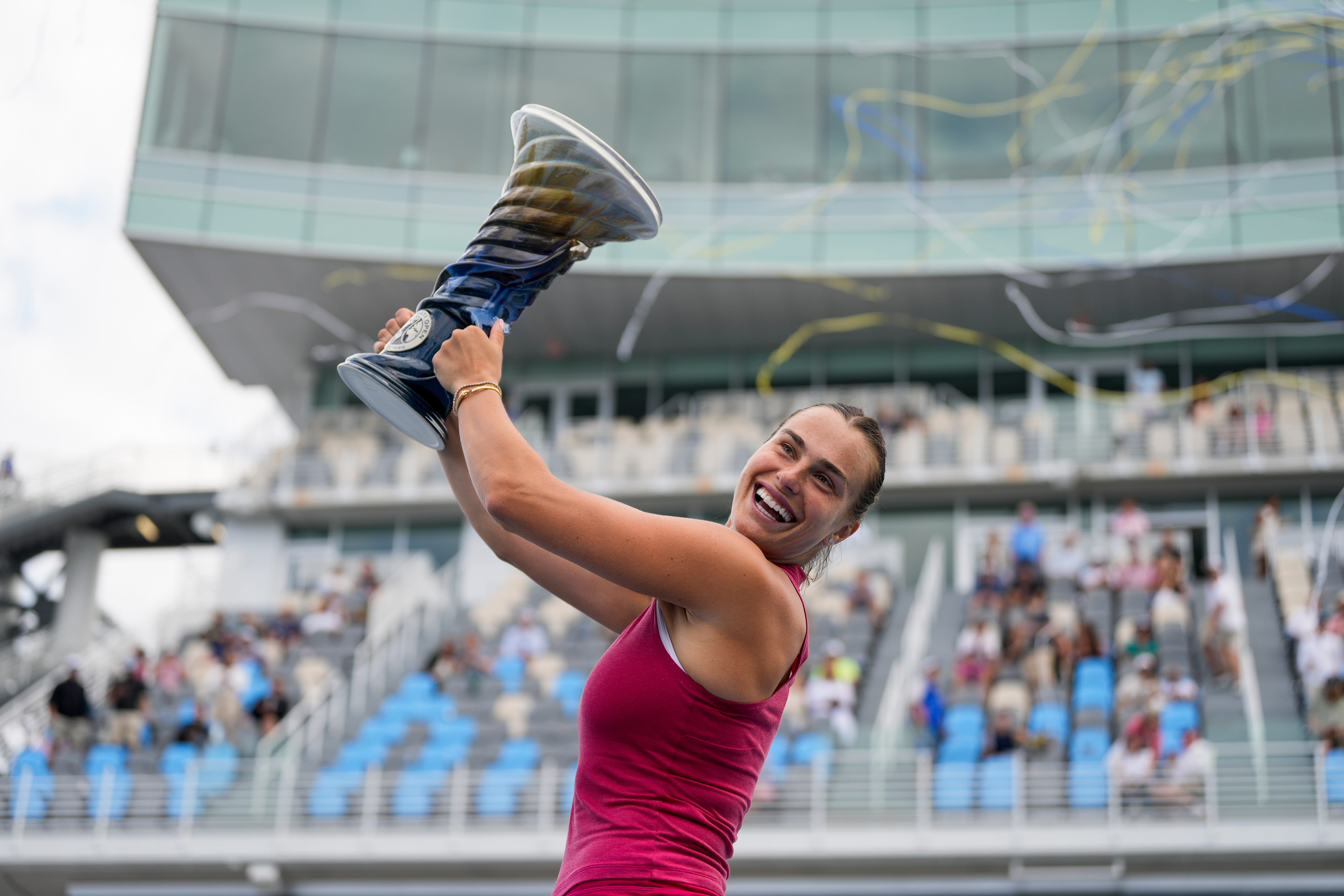 Aryna Sabalenka raises the Rookwood Cup after the women’s championship match of the Cincinnati Open at the Lindner Family Tennis Center in Mason, Ohio, on Monday, Aug. 19, 2024. Aryna Sabalenka defeated Jessica Pegula in straight sets, 6-3, 7-5, for the championship.
