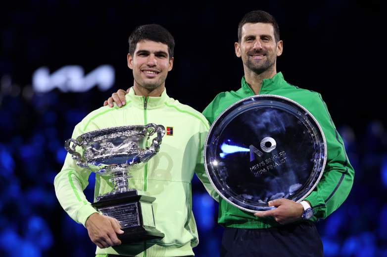 MELBOURNE, AUSTRALIA - FEBRUARY 01: Winner Carlos Alcaraz of Spain and runner-up Novak Djokovic of Serbia pose at the presentation ceremony after the Men's Singles Final during day 15 of the 2026 Australian Open at Melbourne Park on February 01, 2026 in Melbourne, Australia. (Photo by Clive Brunskill/Getty Images)
