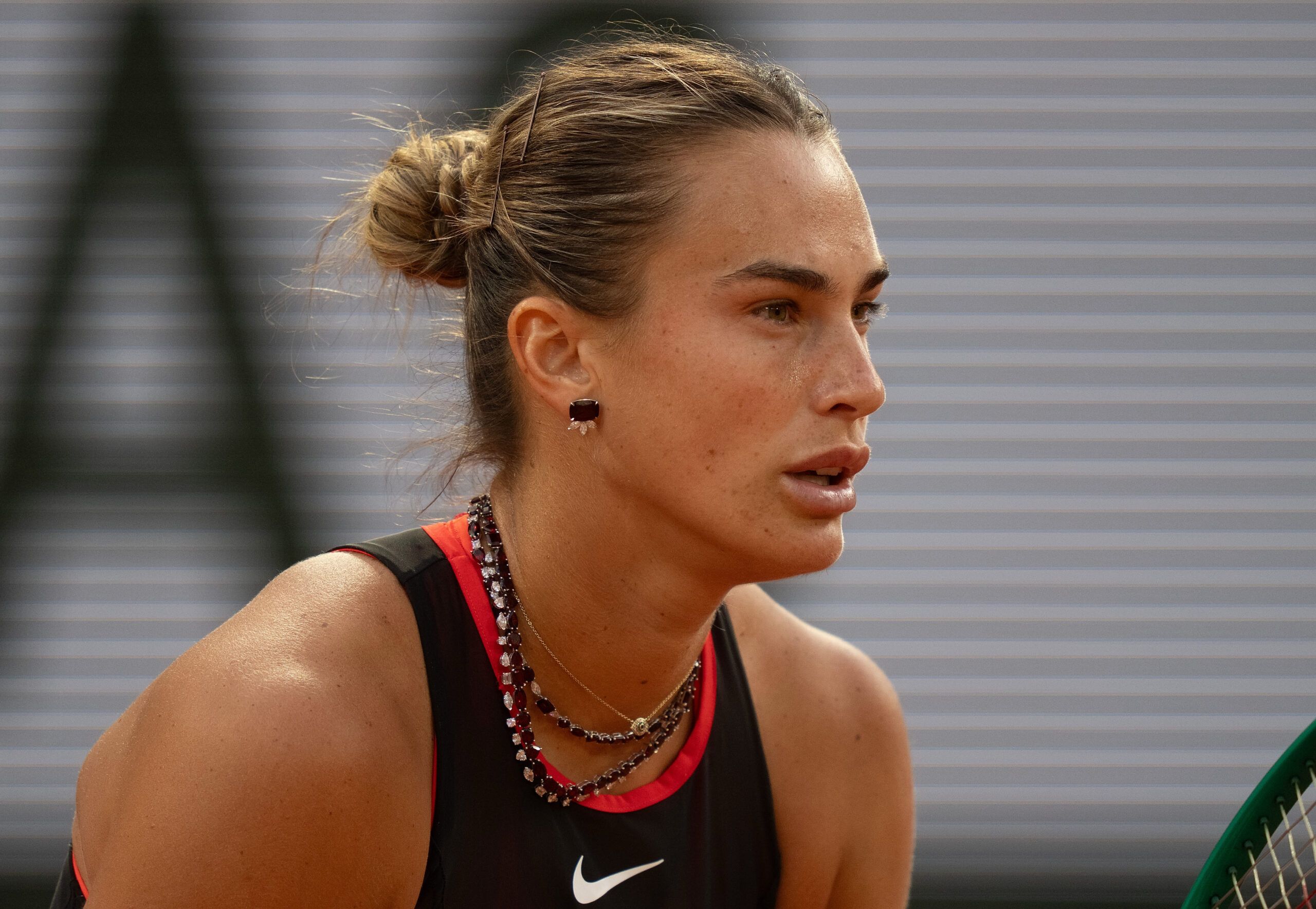 Jun 1, 2026; Paris, France; Aryna Sabalenka wearing her custom 24K diamond necklace during her match against Naomi Osaka of Japan on day nine at Stade Roland Garros. © Susan Mullane-Imagn Images