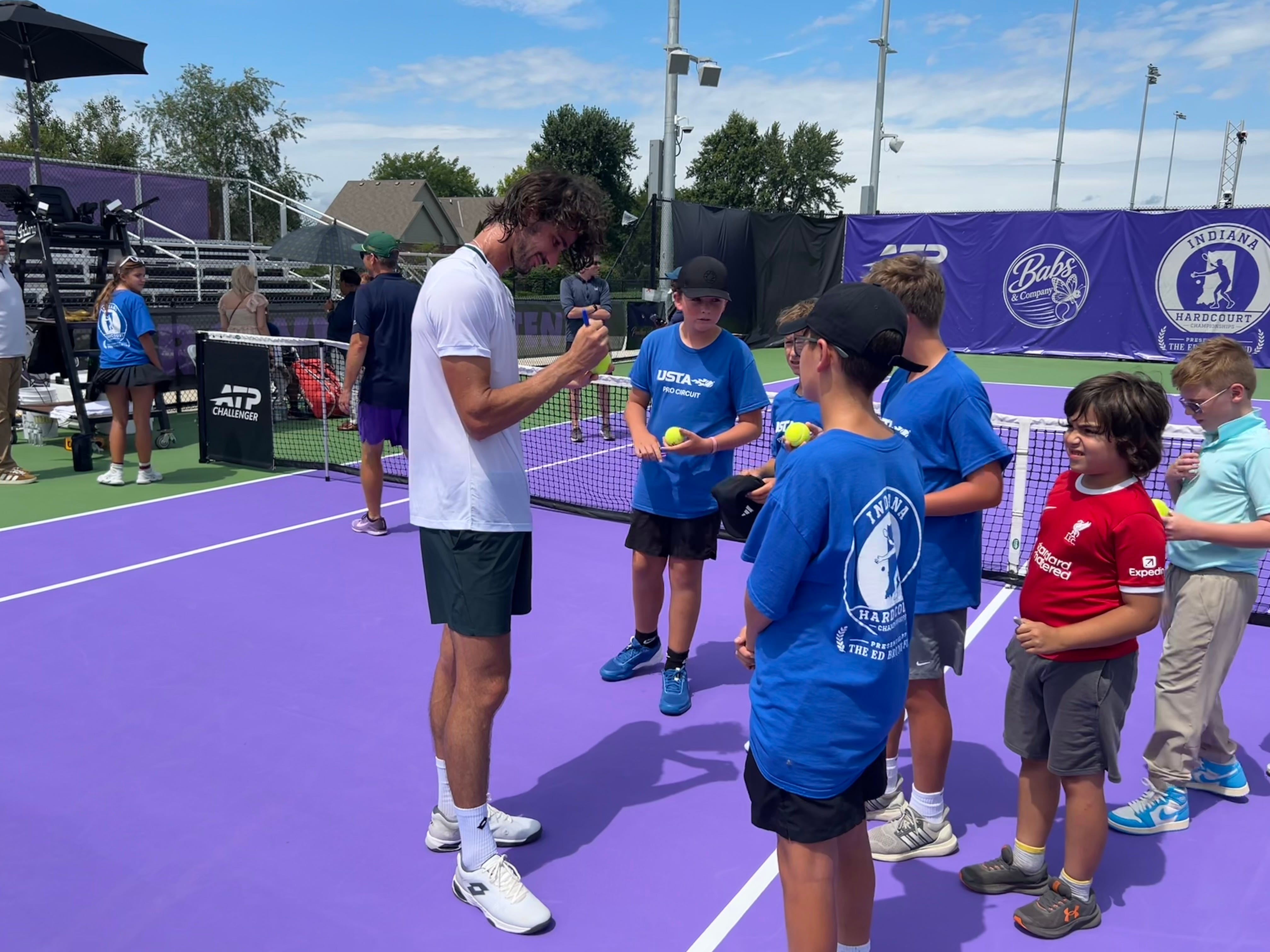 South African professional tennis player Lloyd Harris signs autographs for young fans after he won the singles title at the inaugural Indiana Hardcourt Championships on Sunday, Aug. 16. He beat USA's Andre Ilagan in the finals at Brownsburg High School Tennis Complex.