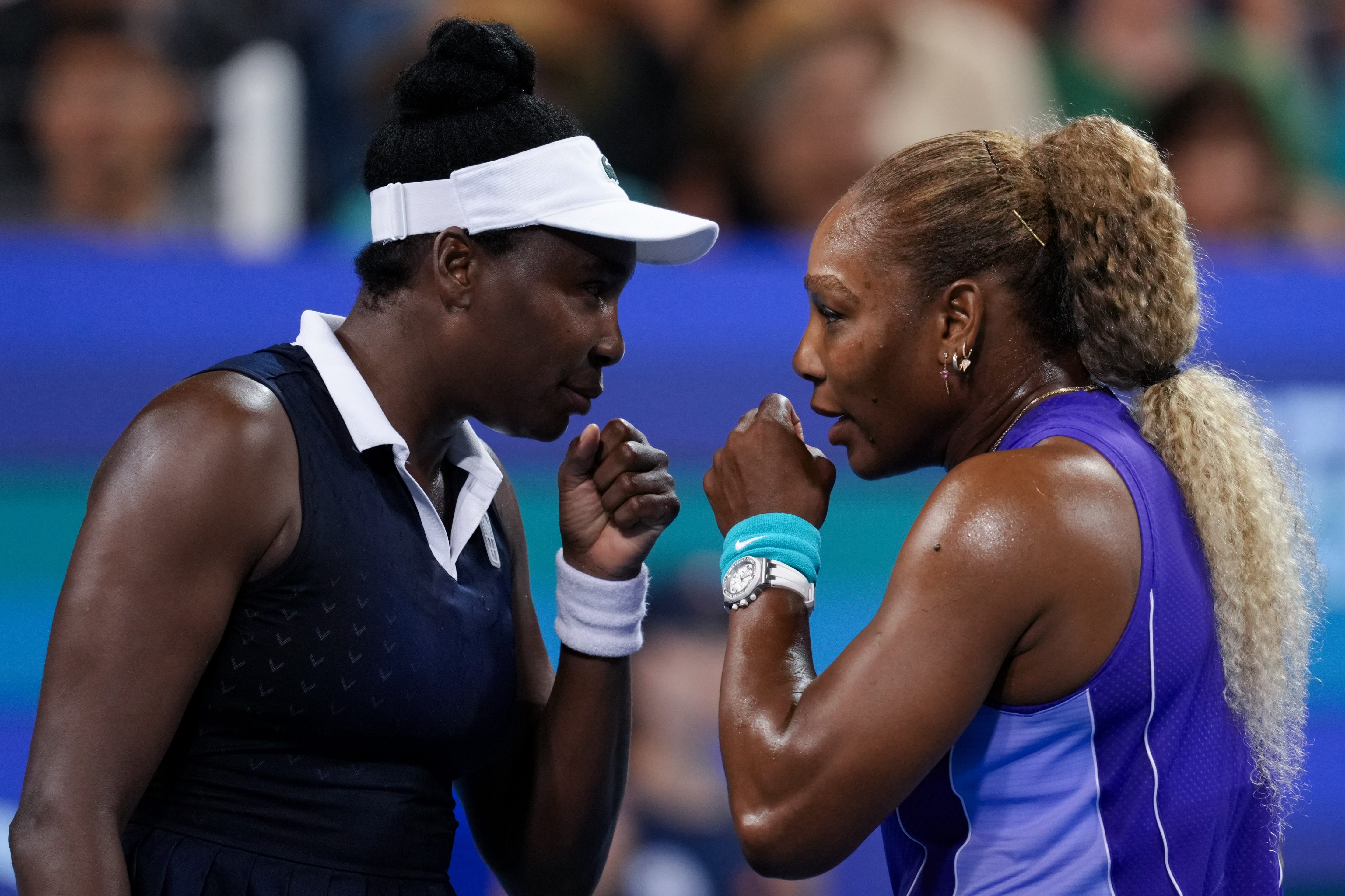 Serena Williams and Venus Williams of the United States confer during their first-round doubles match against Marta Kostyuk of Ukraine and Peyton Stearns of the United States at the 2026 Cincinnati Open.