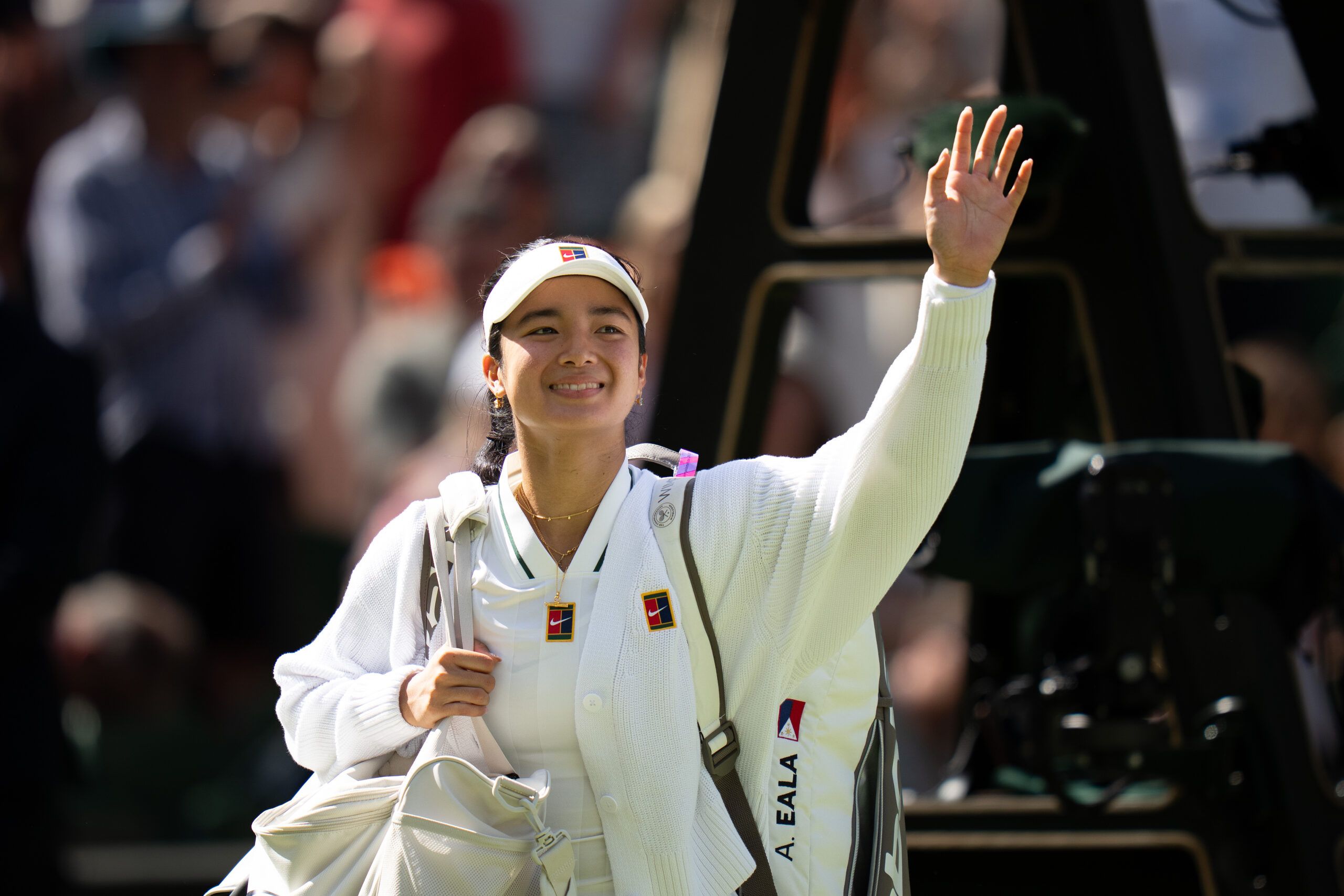 Jul 4, 2026; London, United Kingdom; Alexandra Eala of the Philippinesr waves as she leaves the court after winning her match against Iga Swiatek of Poland on day six at All England Lawn Tennis and Croquet Club. © Susan Mullane-Imagn Images