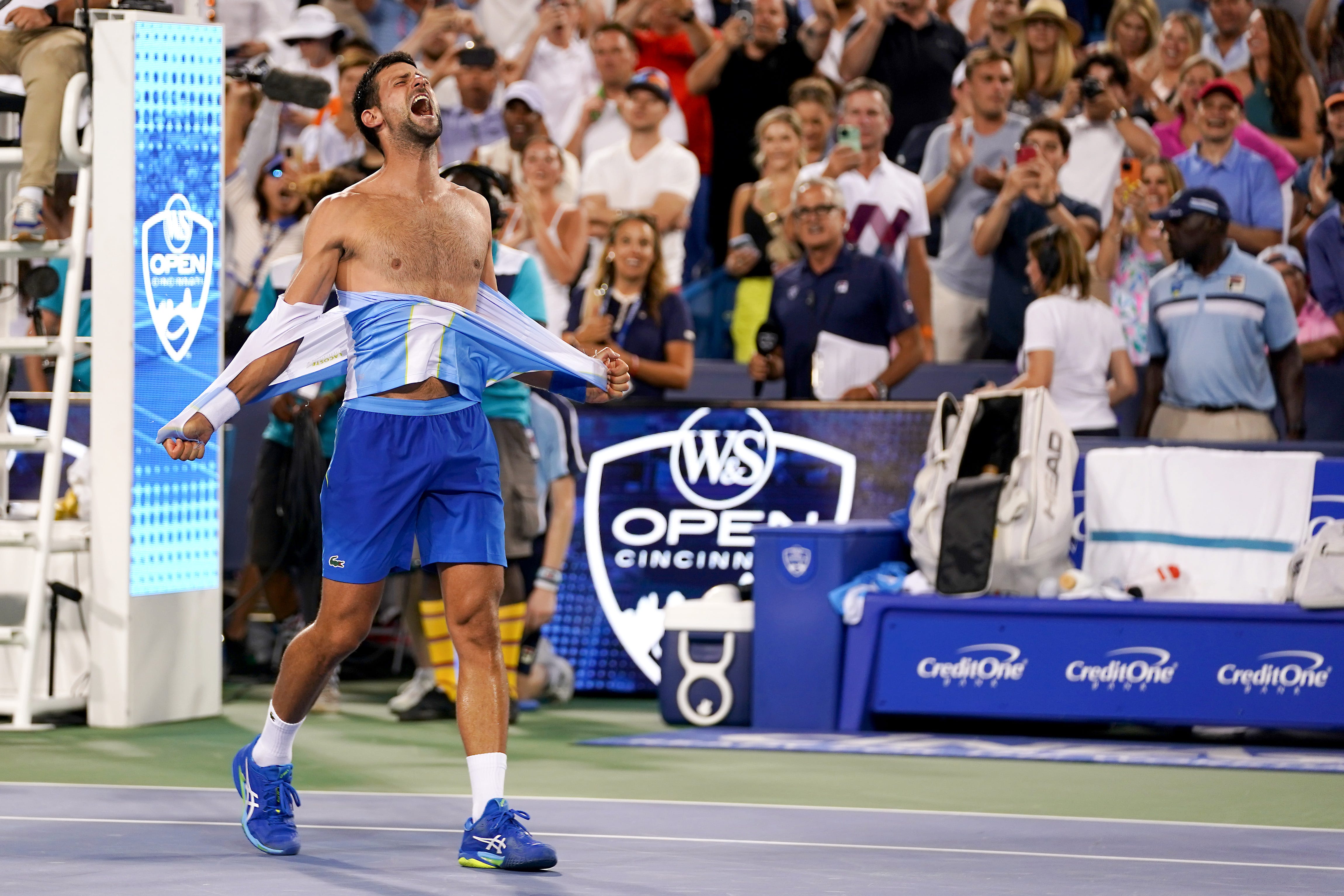 Novak Djokovic, of Serbia, rips his shirt in celebration after defeating Carlos Alcaraz, of Spain, at the conclusion of the menâs singles final of the Western & Southern Open tennis tournament, Sunday, Aug. 20, 2023, at the Lindner Family Tennis Center in Mason, Ohio. Djokovic won, 5-7, 7-6, 7-6.