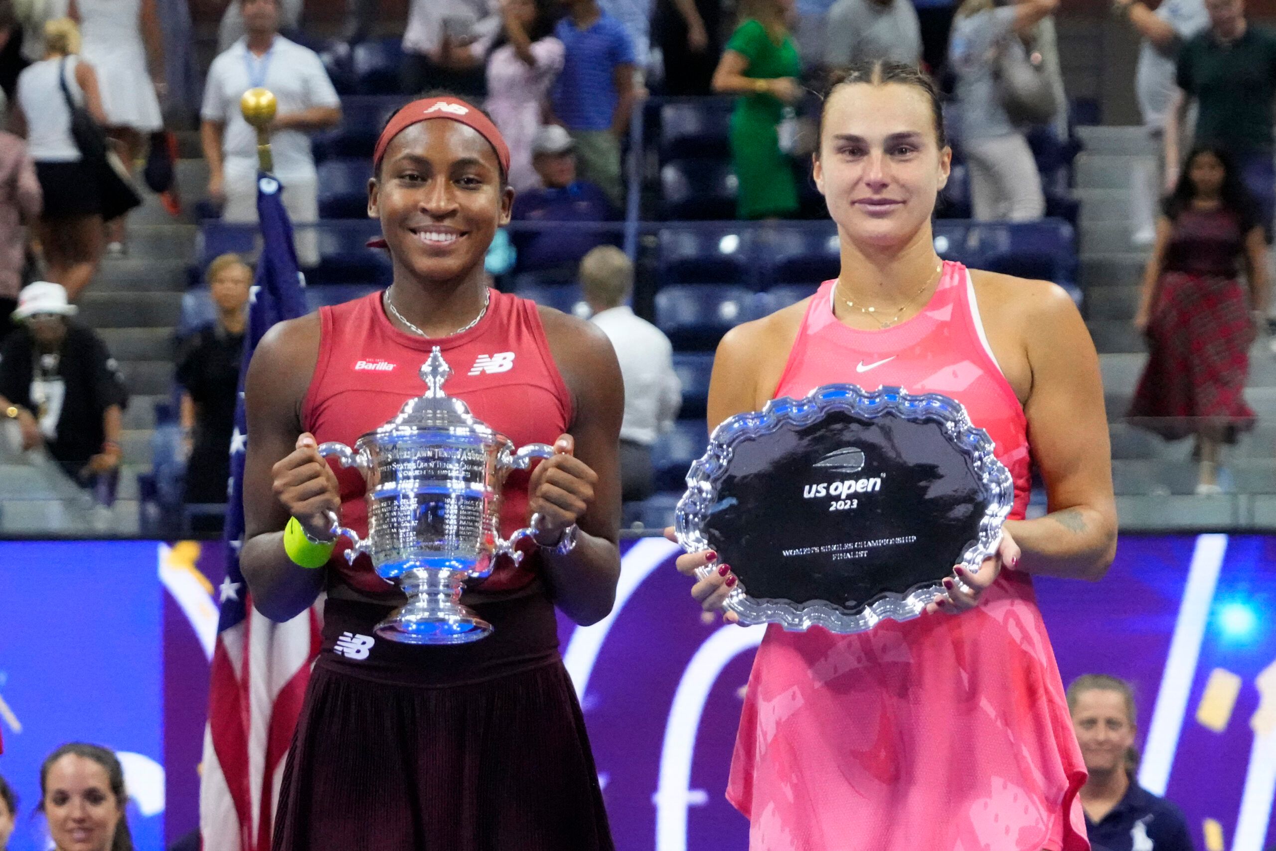 Sep 9, 2023; Flushing, NY, USA; (L-R) Coco Gauff of the United States and Aryna Sabalenka celebrate with the championship and finalist trophies, respectively, after their match in the women's singles finalon day thirteen of the 2023 U.S. Open tennis tournament at USTA Billie Jean King Tennis Center. © Robert Deutsch-USA TODAY Sports