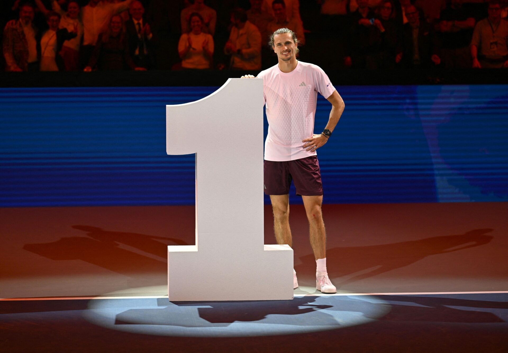 Alexander Zverev poses in front of a big 1 sign